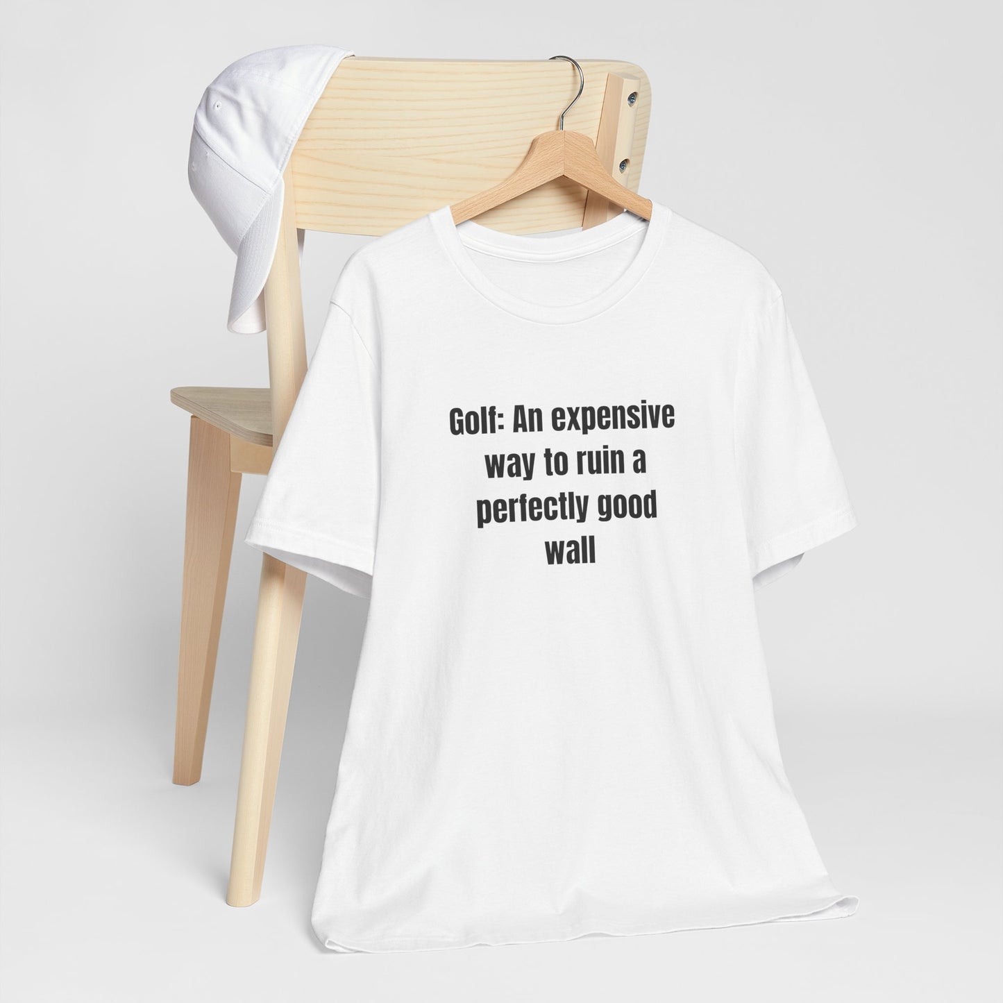 Golf Humor T-Shirt — "Golf: An expensive way to ruin a perfectly good wall"