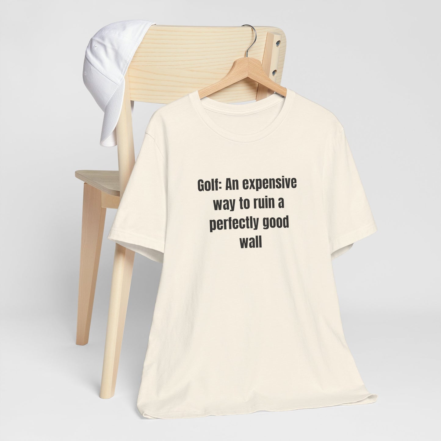 Golf Humor T-Shirt — "Golf: An expensive way to ruin a perfectly good wall"